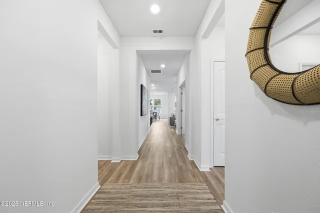 a living room with furniture and a view of kitchen
