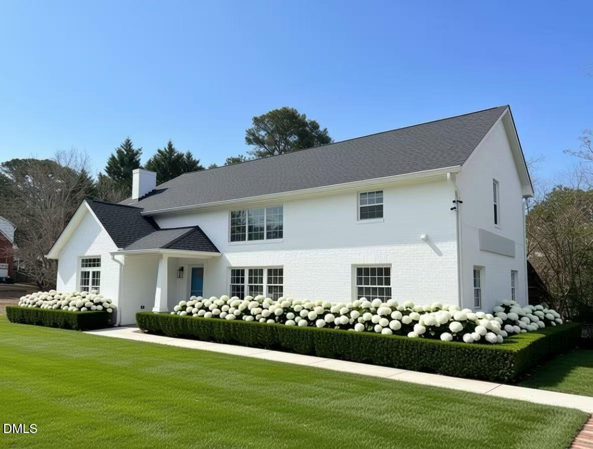 a front view of a house having garden