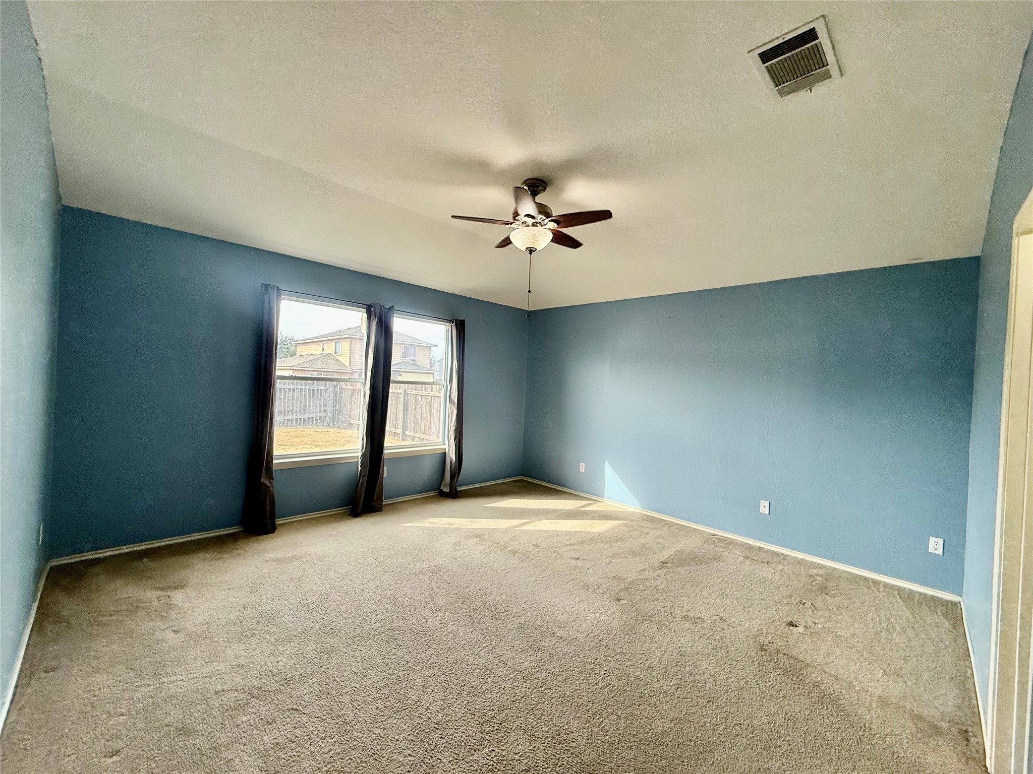 12820 Waynespur Lane Elgin, TX 78621 - Photo 16 of 26 Spare room featuring carpet flooring, ceiling fan, and a textured ceiling