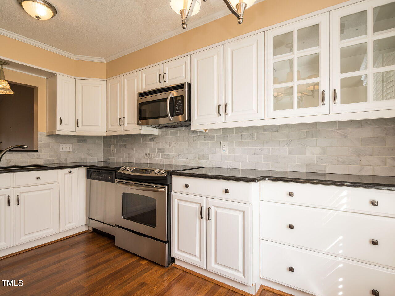 6822 Fairpoint Court Raleigh, NC 27613 - Photo 7 of 25 Updated Kitchen including cabinets including granite countertops.