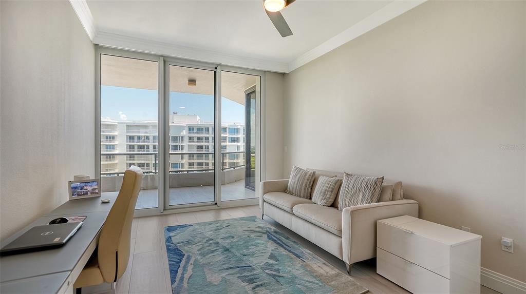 535 Sanctuary Drive, Unit C807 Longboat Key, FL 34228 - Photo 18 of 56 a living room with furniture and a floor to ceiling window