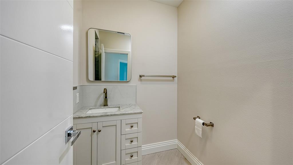 535 Sanctuary Drive, Unit C807 Longboat Key, FL 34228 - Photo 21 of 56 a bathroom with a sink and a mirror