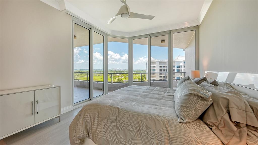 535 Sanctuary Drive, Unit C807 Longboat Key, FL 34228 - Photo 23 of 56 a bed sitting in a bedroom next to a window