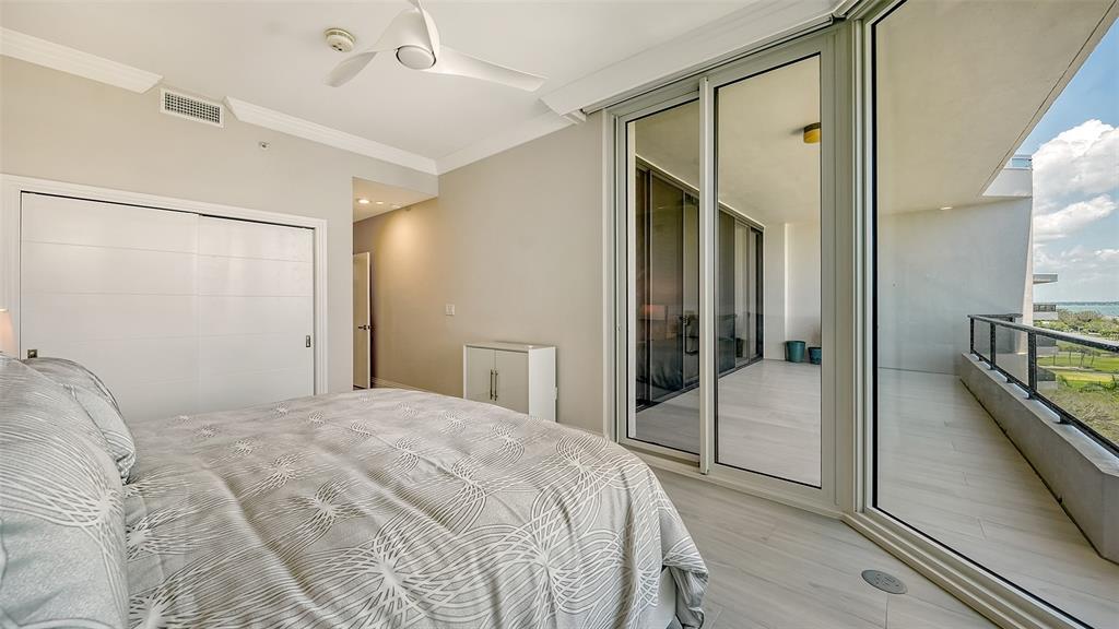 535 Sanctuary Drive, Unit C807 Longboat Key, FL 34228 - Photo 24 of 56 a bedroom with a bed and a walk in closet