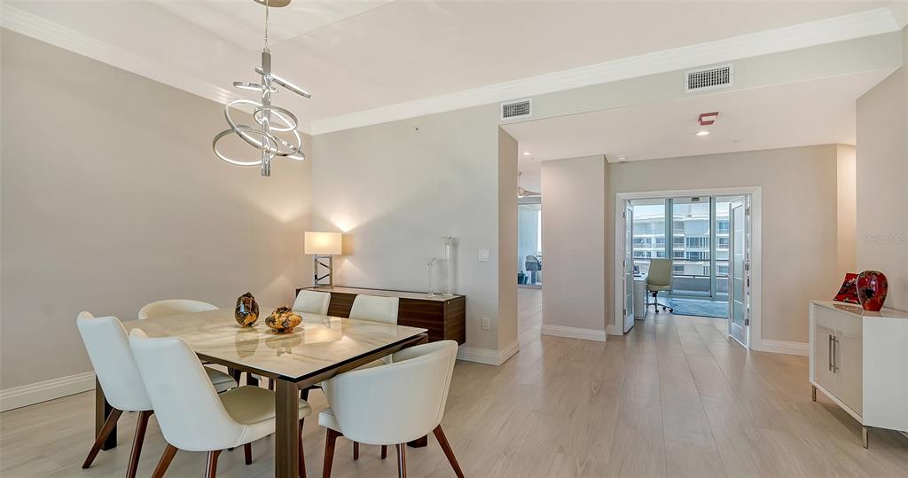 535 Sanctuary Drive, Unit C807 Longboat Key, FL 34228 - Photo 9 of 56 a view of a dining room with furniture and wooden floor