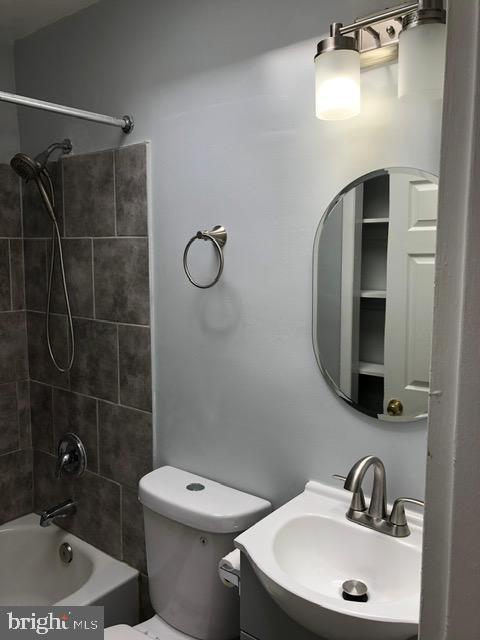 2802 Windsor Avenue Baltimore, MD 21216 - Photo 18 of 37 a bathroom with a sink a toilet and shower