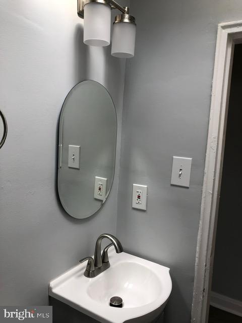 2802 Windsor Avenue Baltimore, MD 21216 - Photo 19 of 37 a bathroom with a sink and a mirror