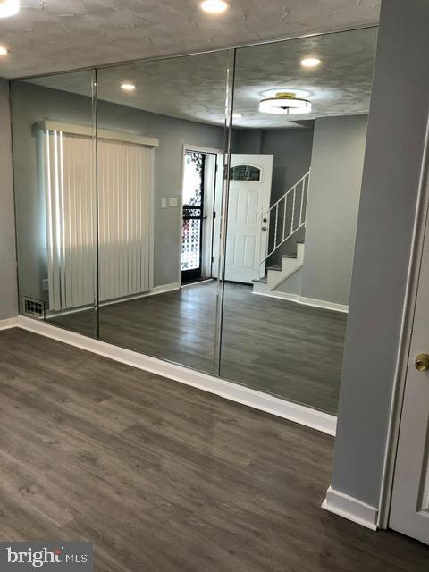 2802 Windsor Avenue Baltimore, MD 21216 - Photo 2 of 37 an empty room with wooden floor and windows