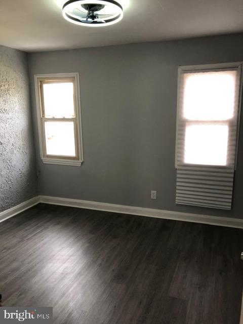 2802 Windsor Avenue Baltimore, MD 21216 - Photo 24 of 37 an empty room with wooden floor and windows