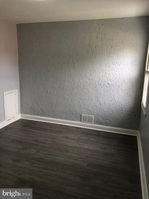 2802 Windsor Avenue Baltimore, MD 21216 - Photo 25 of 37 a view of an empty room with wooden floor