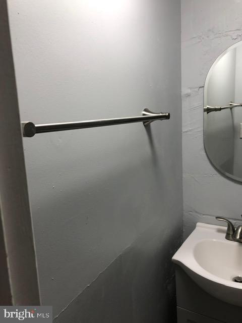 2802 Windsor Avenue Baltimore, MD 21216 - Photo 31 of 37 a bathroom with a sink and mirror