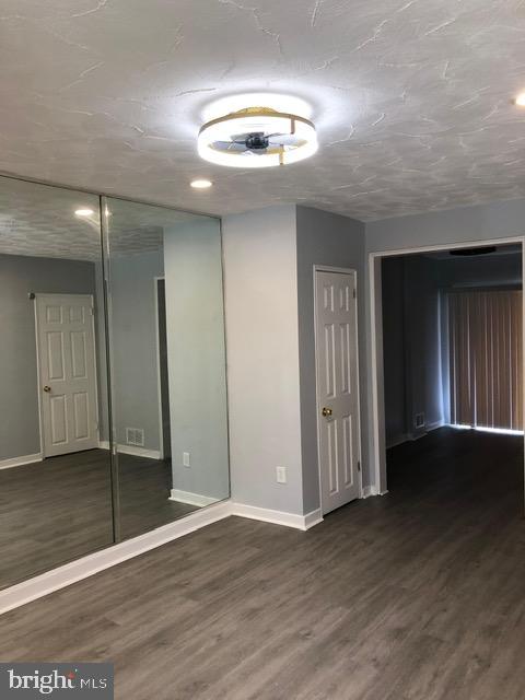 2802 Windsor Avenue Baltimore, MD 21216 - Photo 4 of 37 an empty room with wooden floor and windows
