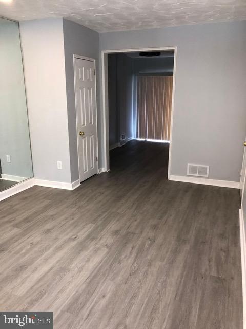2802 Windsor Avenue Baltimore, MD 21216 - Photo 5 of 37 an empty room with wooden floor and windows