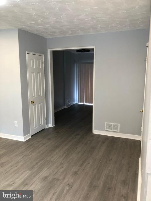 2802 Windsor Avenue Baltimore, MD 21216 - Photo 6 of 37 a view of an empty room with wooden floor