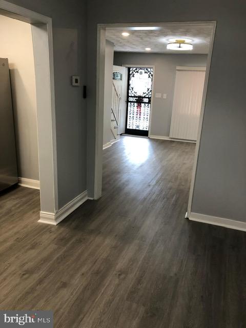 2802 Windsor Avenue Baltimore, MD 21216 - Photo 9 of 37 an empty room with wooden floor and windows