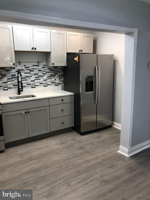 2802 Windsor Avenue Baltimore, MD 21216 - Photo 10 of 37 a kitchen with stainless steel appliances granite countertop a refrigerator and a sink