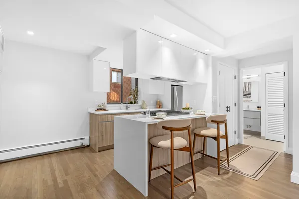 a kitchen with stainless steel appliances a sink stove and cabinets