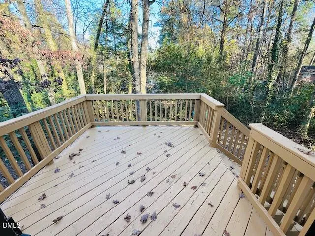 a view of balcony with wooden floor and fence