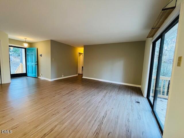 3315 Swansea Street Durham, NC 27707 - Photo 3 of 19 an empty room with wooden floor and entrance