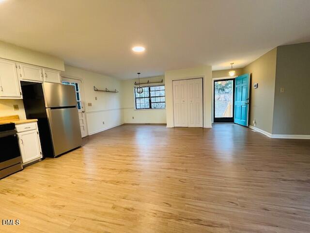 3315 Swansea Street Durham, NC 27707 - Photo 4 of 19 a view of empty room with wooden floor and window