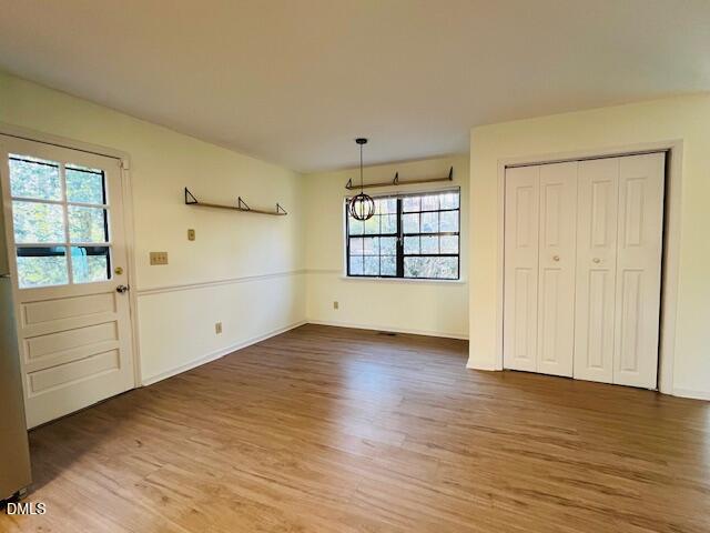 3315 Swansea Street Durham, NC 27707 - Photo 5 of 19 an empty room with wooden floor and cabinet