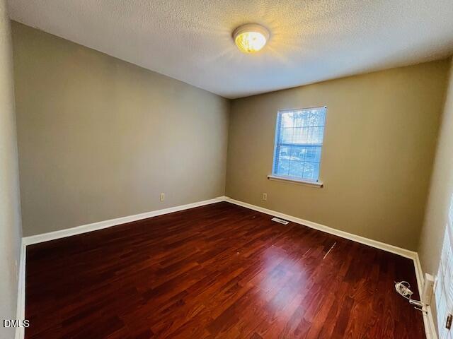 3315 Swansea Street Durham, NC 27707 - Photo 9 of 19 an empty room with wooden floor and windows