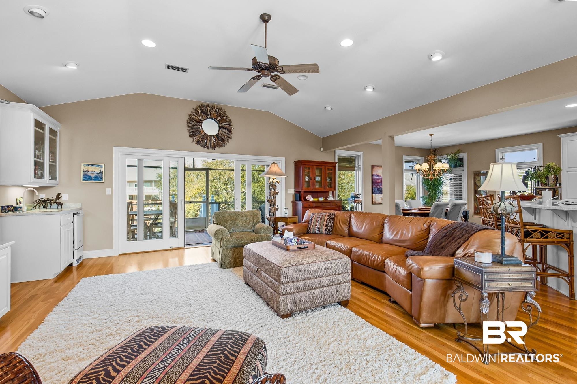 32191 River Road Orange Beach, AL 36561 - Photo 8 of 46 Living room featuring light wood-style floors, a chandelier, and ceiling fan