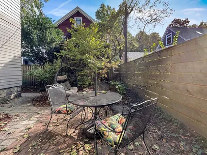 a backyard of a house with table and chairs