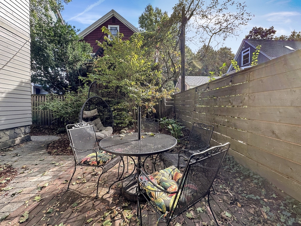 43 Boynton Street, Unit 3R Boston, MA 02130 - Photo 11 of 12 a backyard of a house with table and chairs