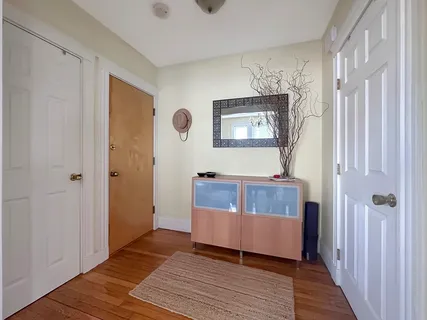 a view of a livingroom with wooden floor and furniture