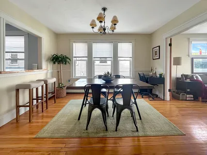 a view of a dining room with furniture window and wooden floor