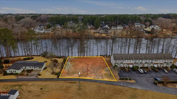 an aerial view of a house with a swimming pool and a yard