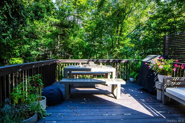 a view of a chairs and tables in the back yard of a house