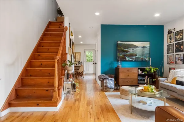 a living room with furniture and stairs