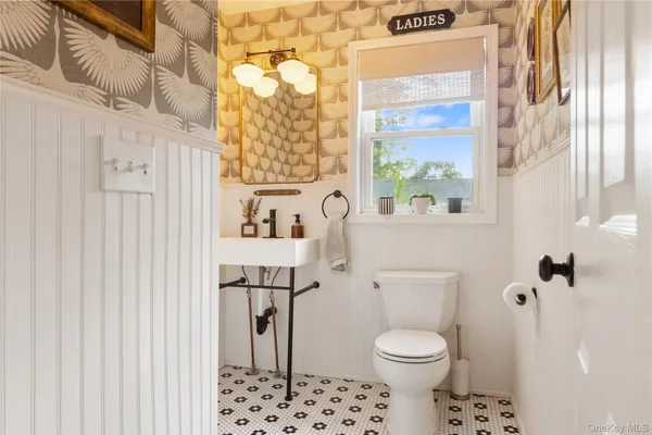 a white toilet sitting next to a bathroom sink