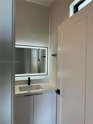 a bathroom with a sink and mirror
