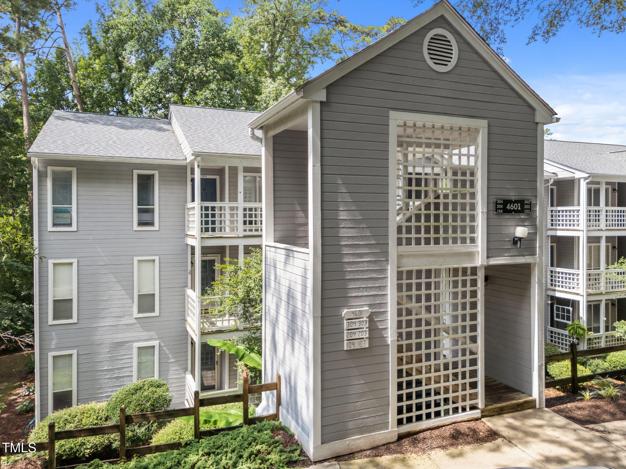 4601 Timbermill Court, Unit 303 Raleigh, NC 27612 - Photo 1 of 37 a front view of a house with a yard