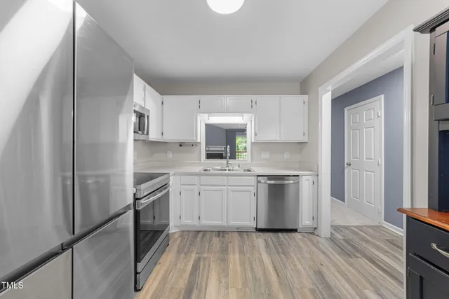 a view of a livingroom with furniture walk in closet area