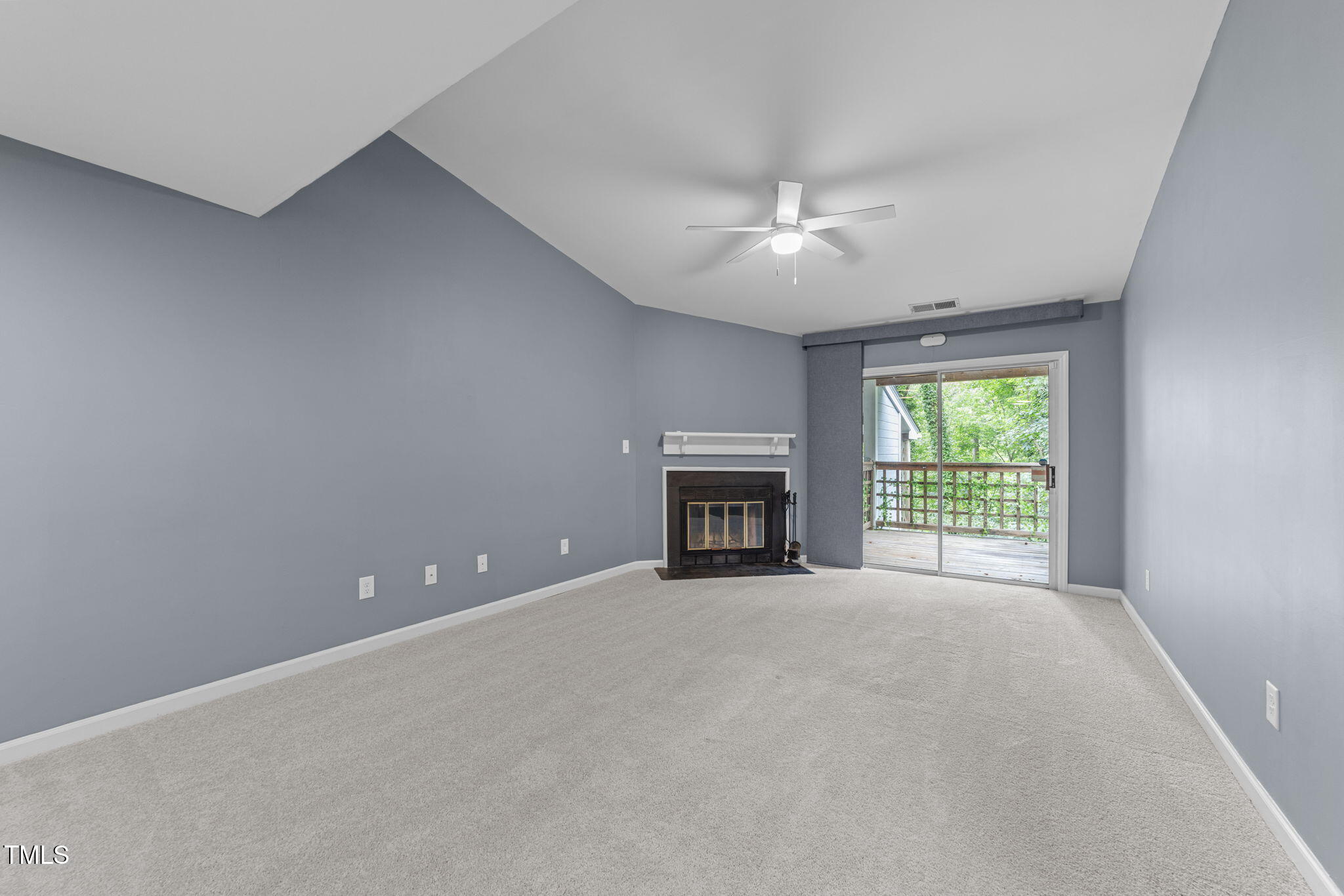 4601 Timbermill Court, Unit 303 Raleigh, NC 27612 - Photo 10 of 37 a view of an empty room with a fireplace and a window