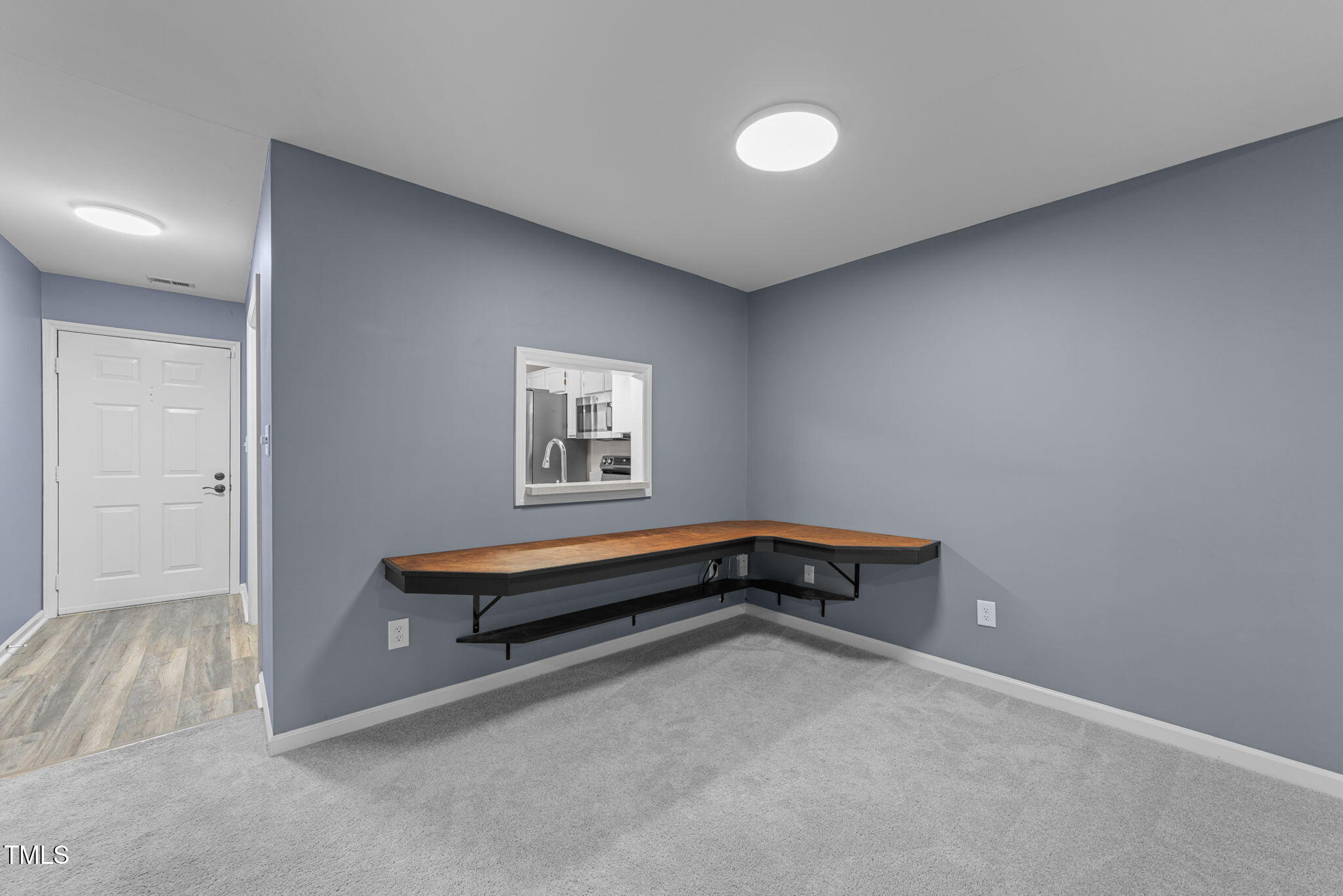 4601 Timbermill Court, Unit 303 Raleigh, NC 27612 - Photo 11 of 37 a living room with a wooden floor and a table