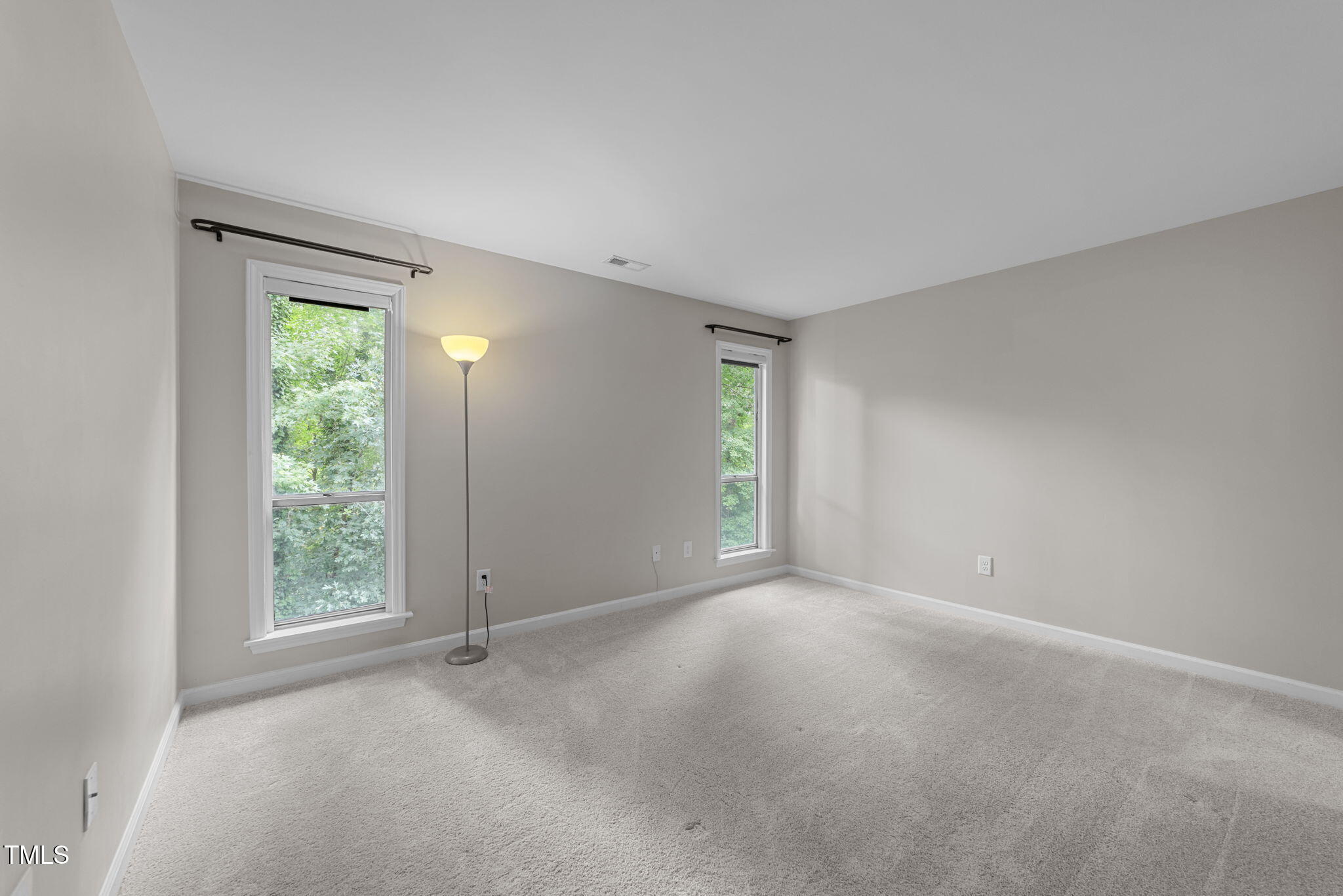 4601 Timbermill Court, Unit 303 Raleigh, NC 27612 - Photo 13 of 37 a view of an empty room with window and closet area