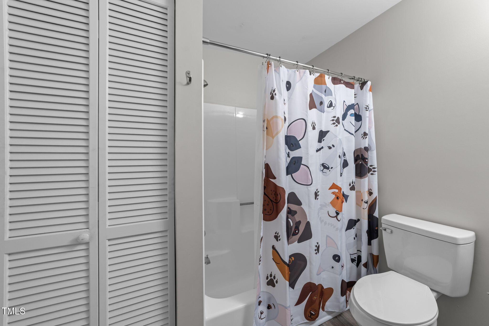 4601 Timbermill Court, Unit 303 Raleigh, NC 27612 - Photo 23 of 37 a white toilet sitting next to a shower curtain