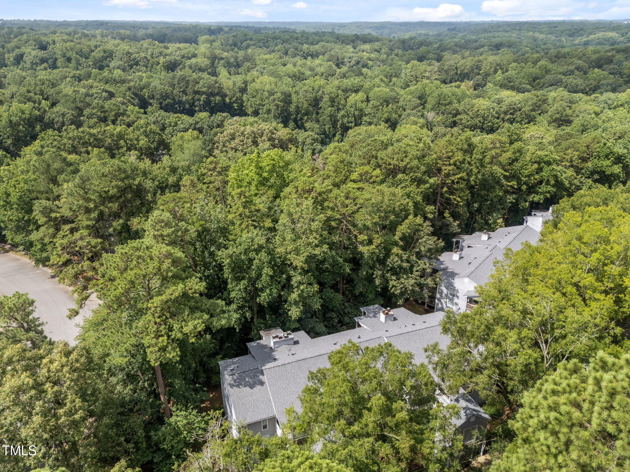 4601 Timbermill Court, Unit 303 Raleigh, NC 27612 - Photo 31 of 37 an aerial view of a house with a yard