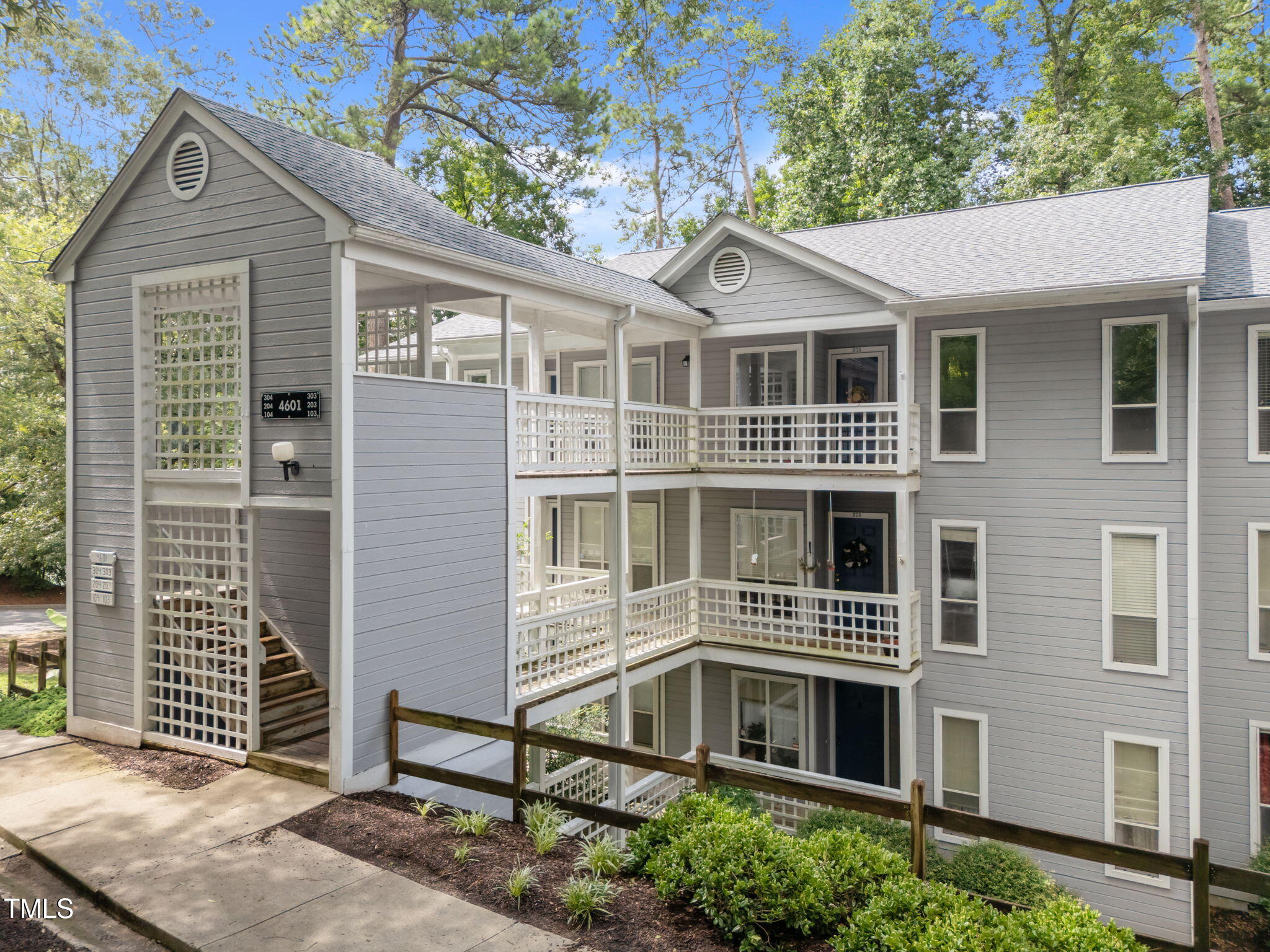 4601 Timbermill Court, Unit 303 Raleigh, NC 27612 - Photo 3 of 37 a front view of a house with a yard