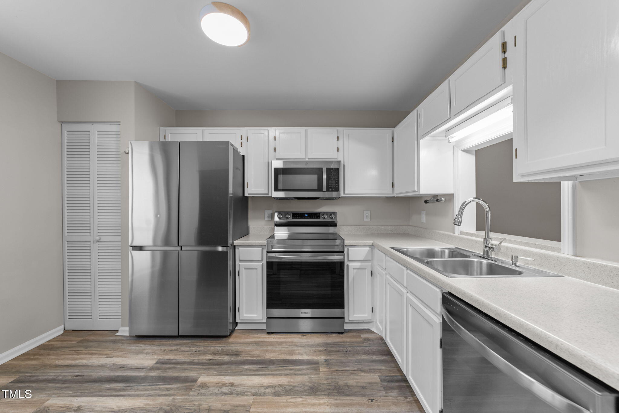 4601 Timbermill Court, Unit 303 Raleigh, NC 27612 - Photo 7 of 37 a kitchen with a sink stove and refrigerator