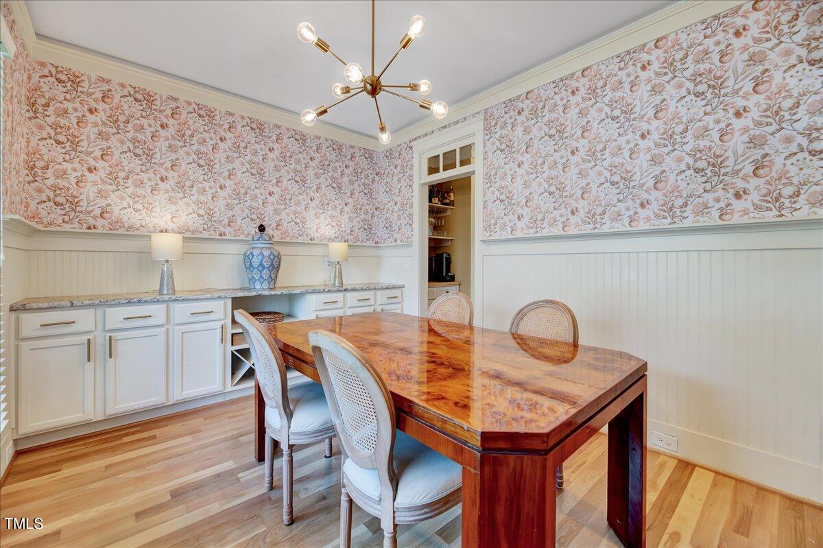 2901 Brighton Bluff Drive Apex, NC 27539 - Photo 11 of 35 a dining room with a wooden table and chairs
