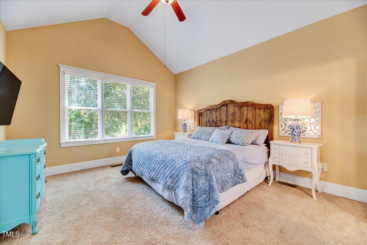 2901 Brighton Bluff Drive Apex, NC 27539 - Photo 15 of 35 a bedroom with a bed and a dresser next to a window