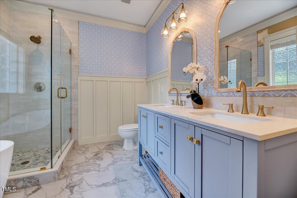 2901 Brighton Bluff Drive Apex, NC 27539 - Photo 18 of 35 a spacious bathroom with a double vanity sink toilet and shower