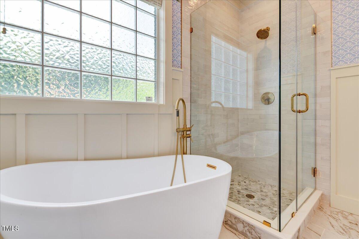 2901 Brighton Bluff Drive Apex, NC 27539 - Photo 19 of 35 a white bath tub sitting next to a shower