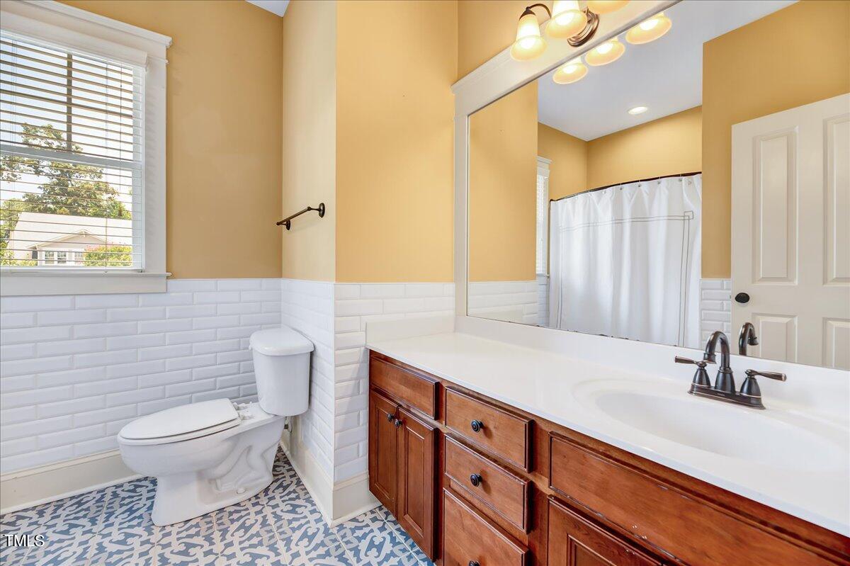 2901 Brighton Bluff Drive Apex, NC 27539 - Photo 22 of 35 a bathroom with a sink a toilet and a mirror